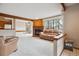 Inviting living area featuring a brick fireplace, large window and open layout at 8095 Garrison Ct # B, Arvada, CO 80005