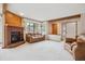 Spacious living room with a cozy brick fireplace and large windows for natural light at 8095 Garrison Ct # B, Arvada, CO 80005