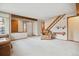 Living room features a carpet floors, staircase, and leather chair with lots of natural light at 8095 Garrison Ct # B, Arvada, CO 80005