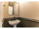 Small bathroom with pedestal sink and green wainscoting at 9112 E 29Th Pl, Denver, CO 80238