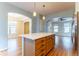 Kitchen island with white countertop and light wood cabinets at 9112 E 29Th Pl, Denver, CO 80238