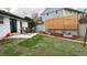 Backyard featuring a well maintained lawn, modern privacy fence and patio with outdoor seating at 7604 Reed St, Arvada, CO 80003