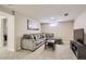 Comfortable carpeted basement with plush sofa and small window at 7604 Reed St, Arvada, CO 80003