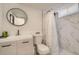 Modern bathroom with a stylish vanity, updated fixtures, and a tiled shower with a curtain at 7604 Reed St, Arvada, CO 80003
