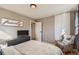 Serene bedroom with comfortable queen-size bed, neutral decor and natural lighting at 7604 Reed St, Arvada, CO 80003