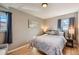 Bright and airy bedroom with hardwood floors, serene decor, and ample natural light for a peaceful retreat at 7604 Reed St, Arvada, CO 80003
