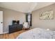 Spacious bedroom with hardwood floors, modern decor, and ample natural light, creating a serene and inviting space at 7604 Reed St, Arvada, CO 80003