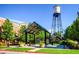 Charming community gathering spot featuring a water tower and lush landscaping in a beautiful park at 7604 Reed St, Arvada, CO 80003
