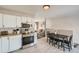 Bright open space with modern kitchen flowing into a dining area, perfect for gatherings at 7604 Reed St, Arvada, CO 80003