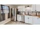 This spacious kitchen offers modern stainless steel appliances, beautiful cabinets, and ample counter space at 7604 Reed St, Arvada, CO 80003