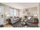 Comfortable living room featuring stylish seating, modern decor, and hardwood floors at 7604 Reed St, Arvada, CO 80003