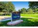 Terrace Park sign surrounded by a lush green lawn and mature trees on a beautiful sunny day at 7604 Reed St, Arvada, CO 80003