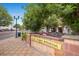 Welcome to Olde Town Arvada sign, sidewalk, restaurant seating, and attractive landscaping enhance the town's charm at 7604 Reed St, Arvada, CO 80003