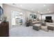 Finished basement with sliding glass doors, comfortable seating, and a large TV at 1224 Sugarloaf Ln, Erie, CO 80516