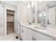 Modern bathroom with double vanity, walk-in shower, and spacious closet at 1224 Sugarloaf Ln, Erie, CO 80516