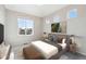 Bright bedroom with large windows, plush bed, and ample natural light at 1224 Sugarloaf Ln, Erie, CO 80516