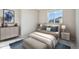 Bright bedroom with a comfortable bed, large window and a dresser at 1224 Sugarloaf Ln, Erie, CO 80516