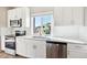 Modern kitchen features white cabinets, stainless steel appliances, and quartz countertops at 1224 Sugarloaf Ln, Erie, CO 80516