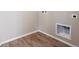 Small laundry room with built-in shelving and wood-look flooring at 1224 Sugarloaf Ln, Erie, CO 80516