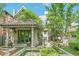 Inviting front entrance featuring a beautiful tile roof, green doors, columns, and lush landscaping at 481 N Humboldt St, Denver, CO 80218