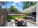Backyard features a patio with outdoor seating, string lights, well-kept lawn, garden, and privacy fence at 8051 W 78Th Cir, Arvada, CO 80005