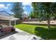 Backyard with a covered patio, outdoor seating, a well-maintained lawn, and landscaping with a wood fence at 8051 W 78Th Cir, Arvada, CO 80005