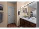 Well-lit bathroom featuring a vanity with a sink and a framed mirror at 8051 W 78Th Cir, Arvada, CO 80005