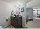 Basement bathroom with modern vanity and a doorway leading to living area at 8051 W 78Th Cir, Arvada, CO 80005