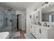 Bright bathroom offers double sinks, a luxurious shower, and ample storage space, all designed with modern finishes at 8051 W 78Th Cir, Arvada, CO 80005