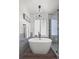 Elegant bathroom with modern tub, walk-in shower, and natural light for a serene and spa-like experience at 8051 W 78Th Cir, Arvada, CO 80005