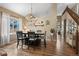 Dining area featuring hardwood floors, a dining table and a view to the kitchen at 8051 W 78Th Cir, Arvada, CO 80005