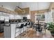 Bright and modern kitchen with white cabinets, bar top seating, and hardwood floors at 8051 W 78Th Cir, Arvada, CO 80005