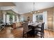 Open-concept living and dining area with vaulted ceilings and hardwood floors at 8051 W 78Th Cir, Arvada, CO 80005