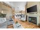 Open floor plan with hardwood floors seamlessly connects the living room with the modern kitchen at 8051 W 78Th Cir, Arvada, CO 80005