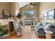 Cozy living room features hardwood floors, a fireplace, high ceilings, and sliding door access to the backyard at 8051 W 78Th Cir, Arvada, CO 80005