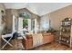 Cozy living room featuring a leather couch, natural lighting, and hardwood floors at 8051 W 78Th Cir, Arvada, CO 80005
