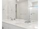 Bright bathroom with double vanity with quartz counters and chrome fixtures at 552 Red Rock Pl, Brighton, CO 80601
