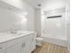 Bright white bathroom features a vanity, mirror, and shower-tub combination at 552 Red Rock Pl, Brighton, CO 80601