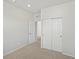 Neutral bedroom with sliding closet doors and carpet, offering ample storage space at 552 Red Rock Pl, Brighton, CO 80601