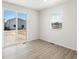 Bright bedroom with sliding glass doors leading to the backyard at 552 Red Rock Pl, Brighton, CO 80601
