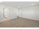 Bedroom features neutral carpet, recessed lighting, and view to en-suite bathroom at 552 Red Rock Pl, Brighton, CO 80601
