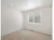 Neutral bedroom with carpet, natural light from window, and white walls at 552 Red Rock Pl, Brighton, CO 80601