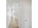 Bright hallway with light wood floors and white walls offers a view into the rest of the home at 552 Red Rock Pl, Brighton, CO 80601