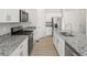Well-equipped kitchen with stainless steel appliances and granite countertops at 552 Red Rock Pl, Brighton, CO 80601