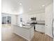 Modern kitchen with stainless steel appliances, granite countertops, and an island with sink at 552 Red Rock Pl, Brighton, CO 80601