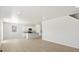 Open-concept living room flowing into a modern kitchen with stainless appliances at 552 Red Rock Pl, Brighton, CO 80601