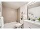 Bright bathroom featuring a shower-over-tub, and white vanity at 10211 Ura Ln # 7-204, Thornton, CO 80260