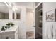 Bright bathroom with walk-in closet and white vanity at 10211 Ura Ln # 7-204, Thornton, CO 80260