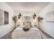 Inviting bedroom with neutral tones, decorative wall art, and a cozy bed at 10211 Ura Ln # 7-204, Thornton, CO 80260