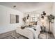 Relaxing bedroom featuring neutral colors, decorative wall art, and a comfortable bed at 10211 Ura Ln # 7-204, Thornton, CO 80260